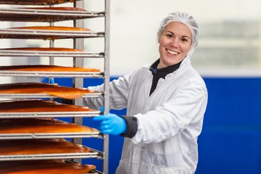 Employee at the factory with salmon