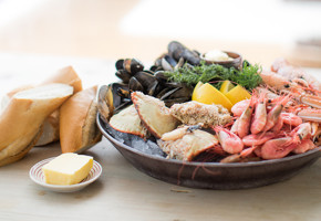 Mussels, shrimps, crab on a plate with bread on the side
