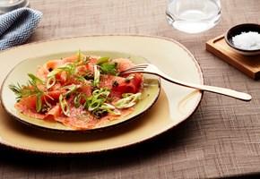 Carpaccio of smoked trout served with spring onion and lemon